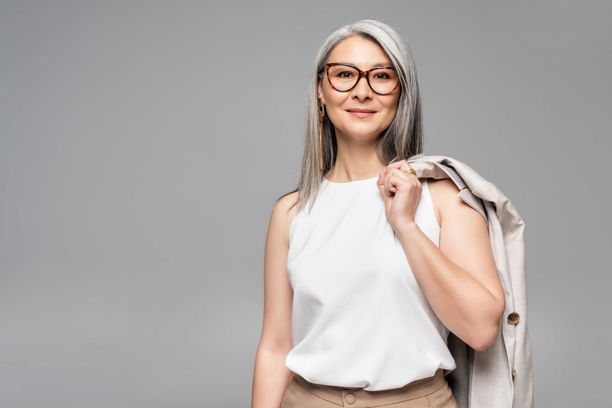 Strong and bold woman standing with jacket over her shoulder